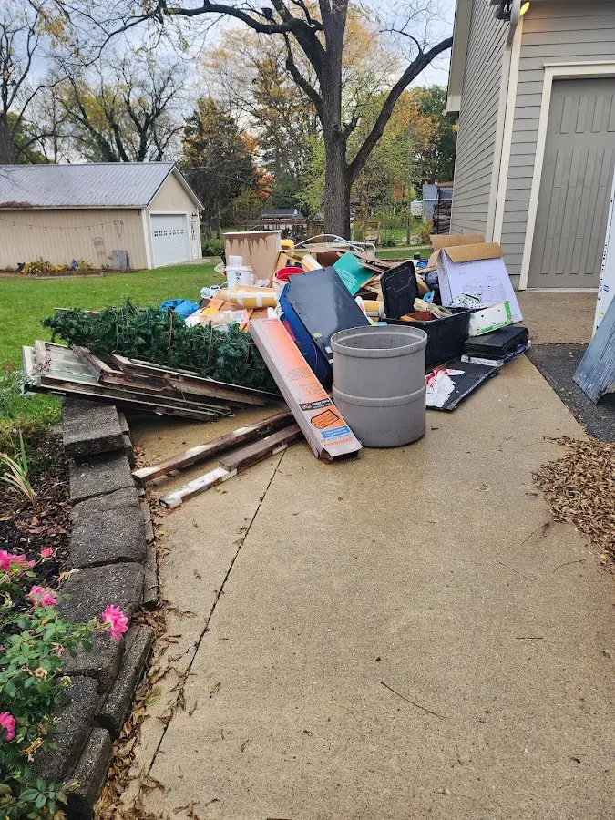 Dumpster being loaded with debris for Estate Cleanout Dumpster Rental in Old Orchard Beach